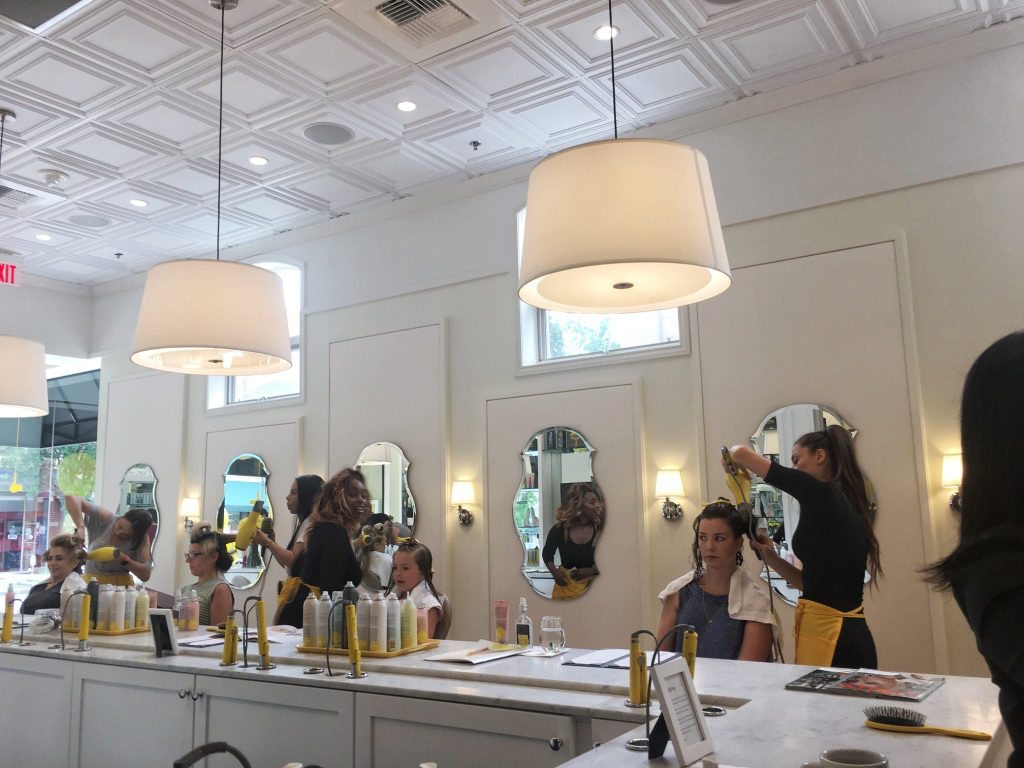 Stylists giving the girls blowouts at DryBar Summit 